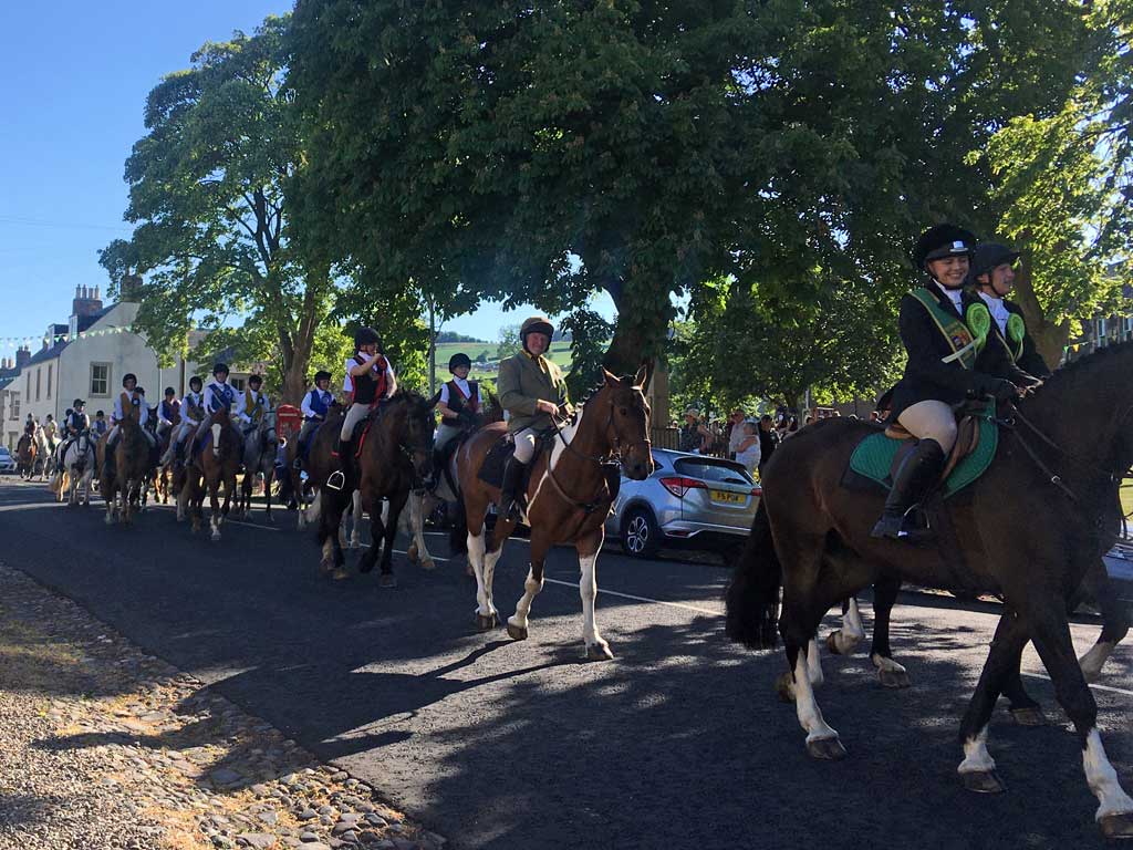 Cavalcade of horse riders on Town Yetholm high street